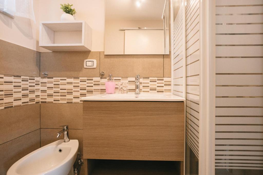 Un bagno con doccia, finestra luminosa e dispenser di shampoo e shower gel.